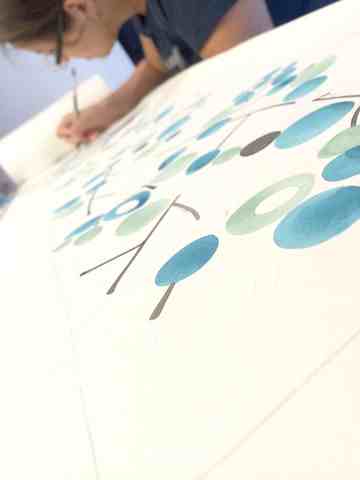Elena working on a very long 9 meter handmade isle runner > Watercolor painting on canvas